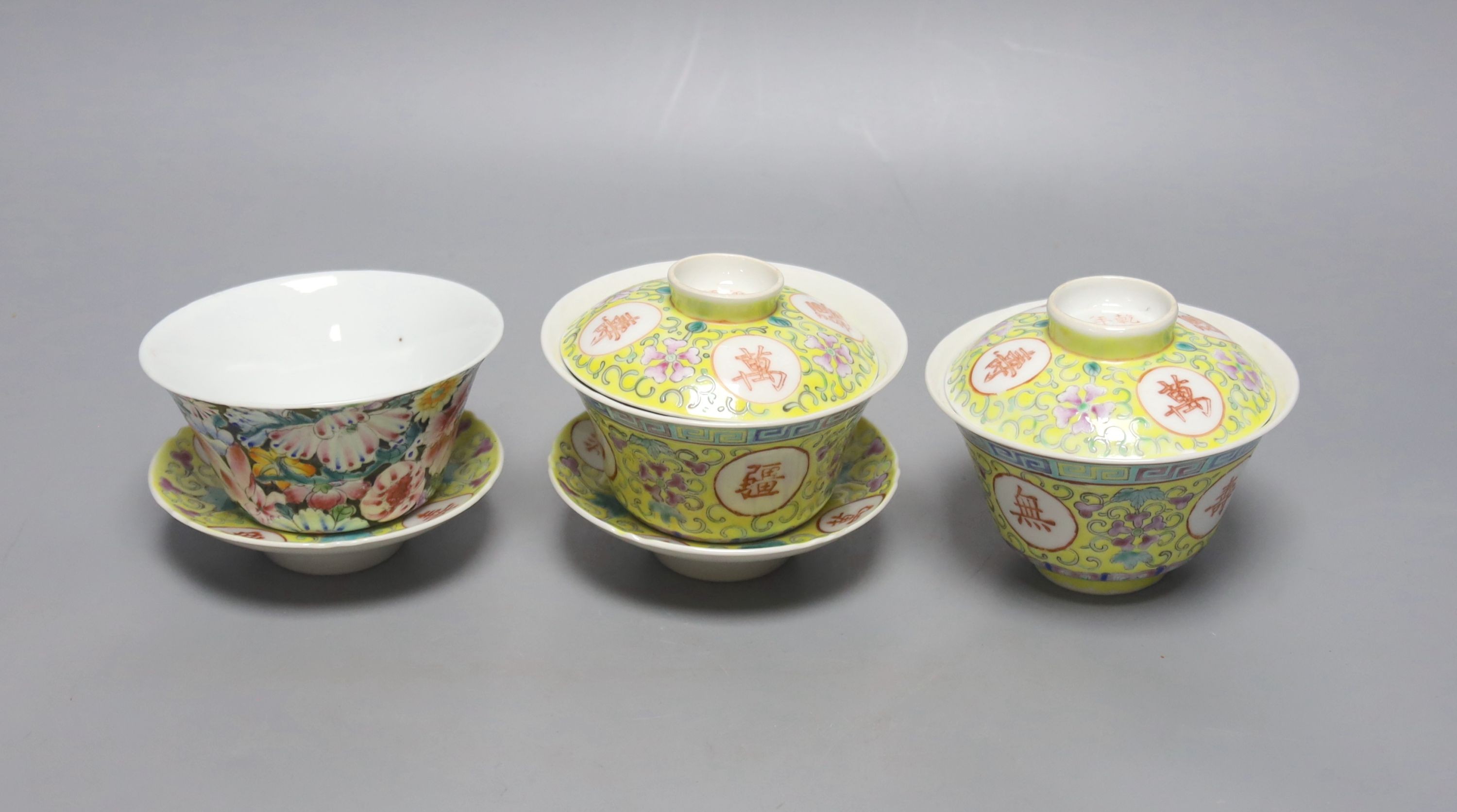 A pair of Chinese enamelled porcelain rice bowls, covers and stands and an odd bowl